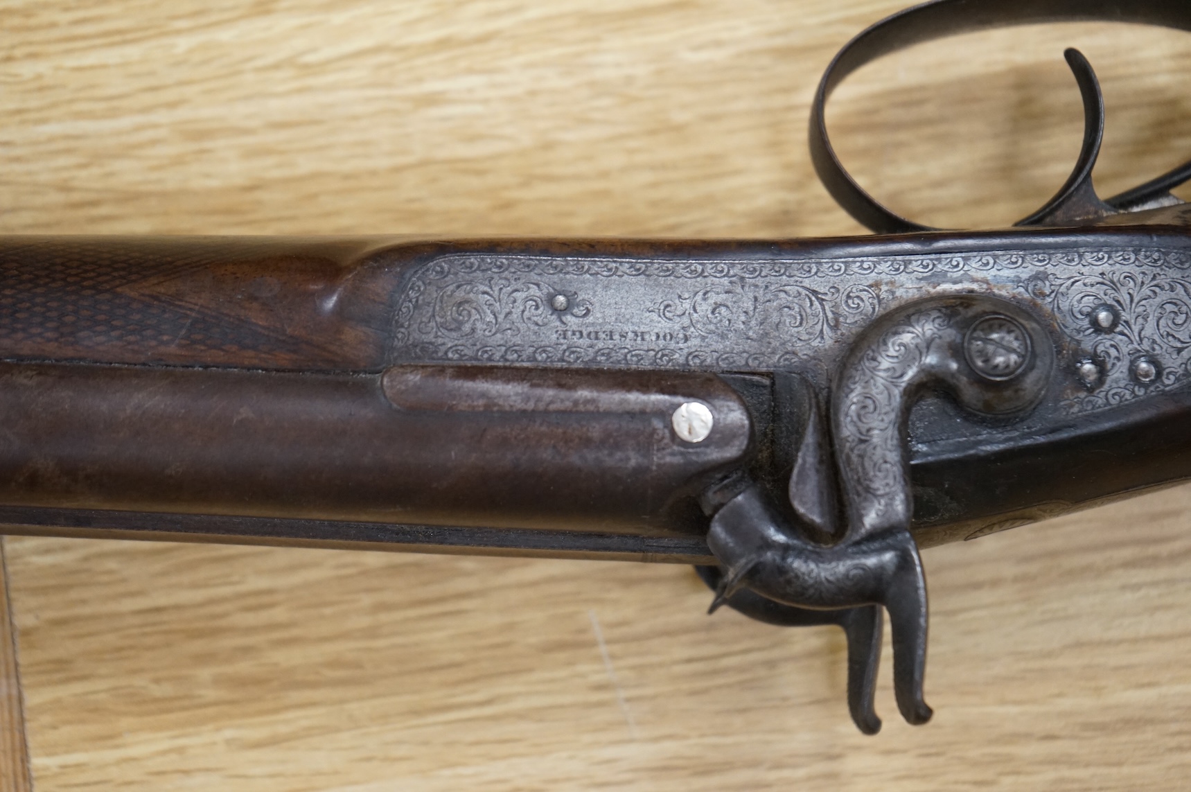 A double barrel 12 bore percussion sporting gun, signed Cocksedge, Hadleigh, with engraved locks and iron furniture, half stocked chequered grip with finger support in wood above guard